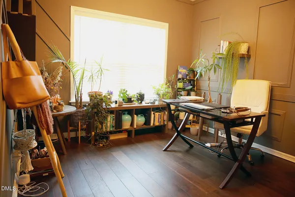 a view of a workspace with furniture and a window