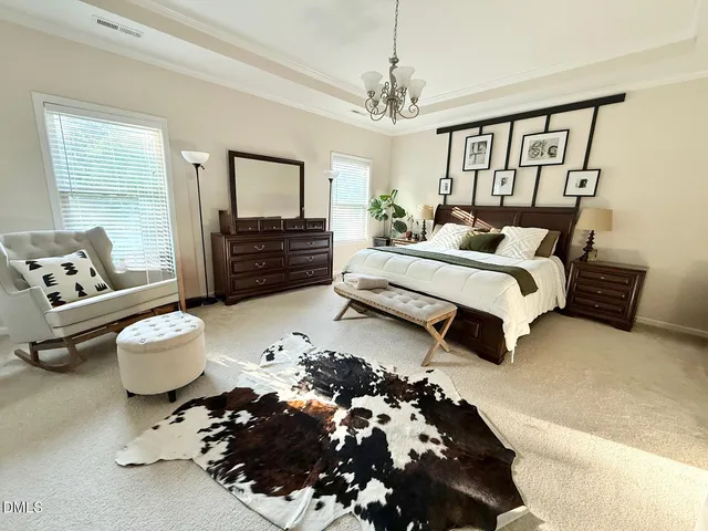 a spacious bedroom with a bed and window