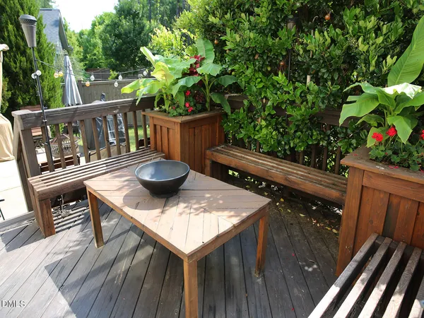 a view of deck with furniture and trees