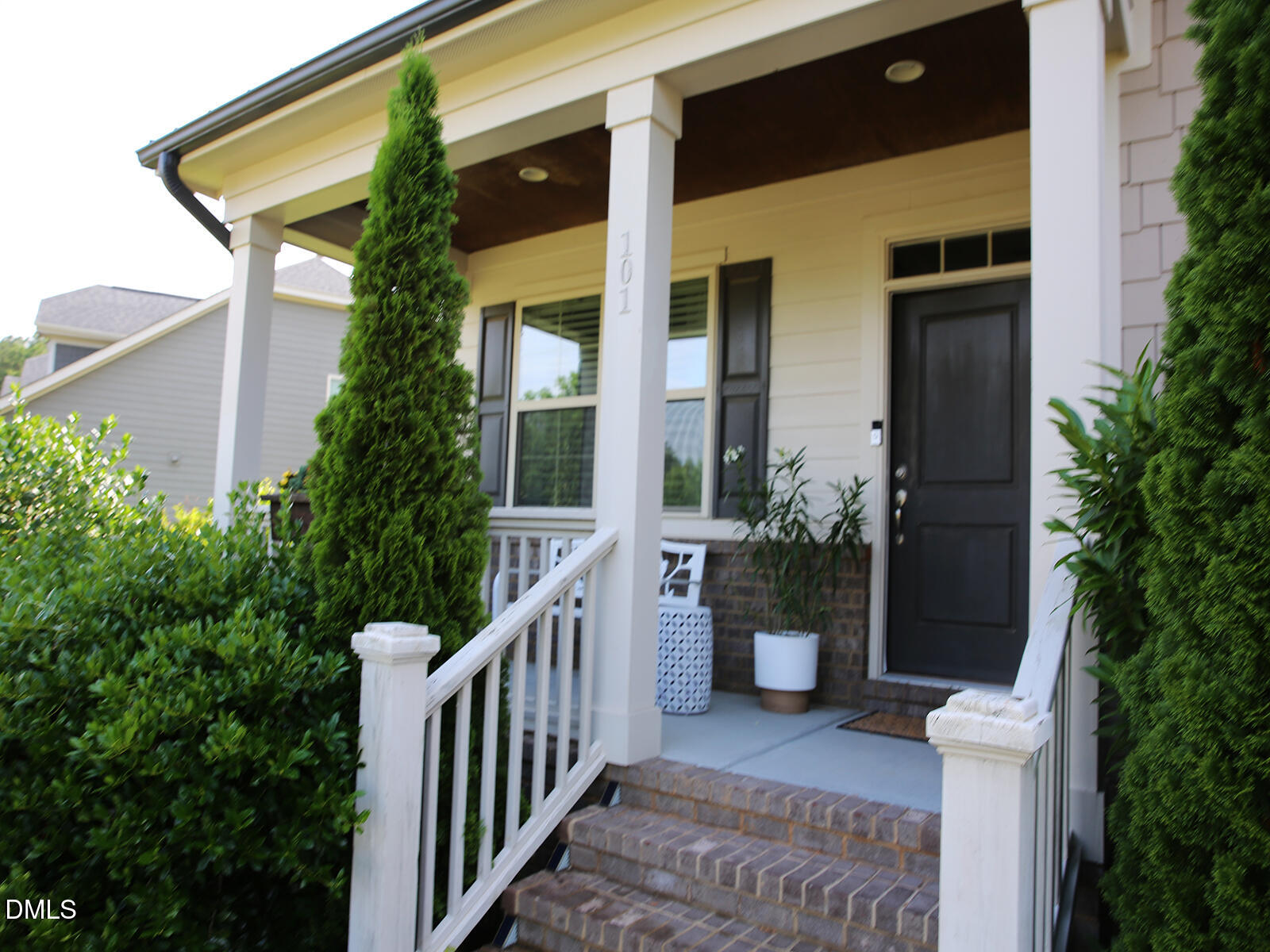 101 Inkwood Place Cary, NC 27519 - Photo 4 of 35 a view of a house with potted plants and a bench