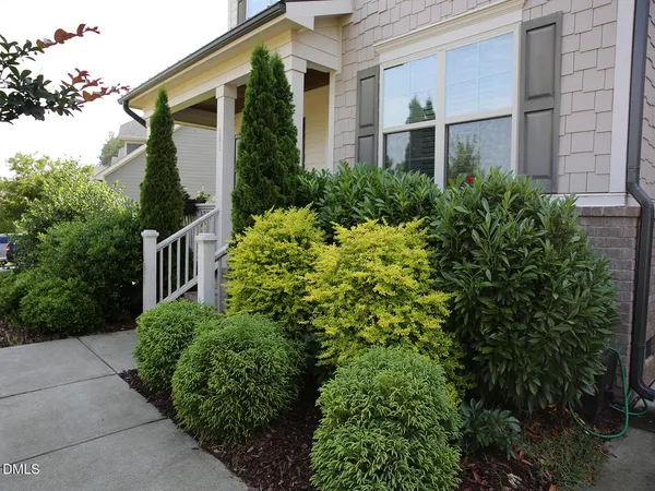 a view of a house with brick walls and plants