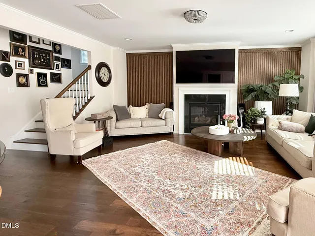 a living room with furniture a fireplace and a flat screen tv