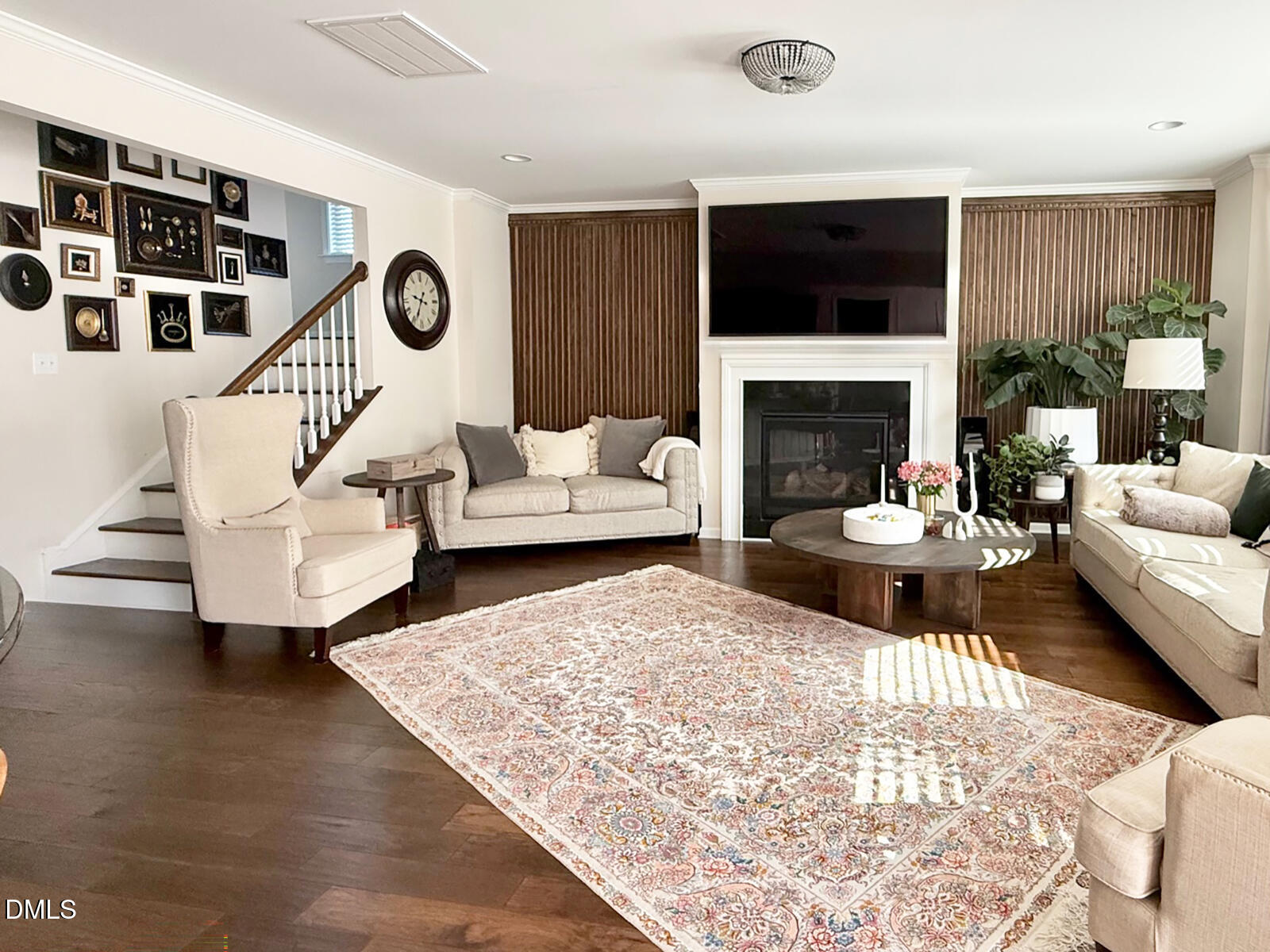 101 Inkwood Place Cary, NC 27519 - Photo 10 of 35 a living room with furniture a fireplace and a flat screen tv