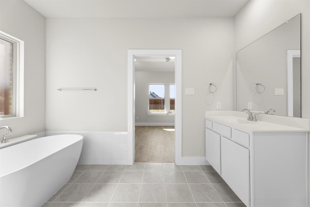 2359 Bell Way Forney, TX 75126 - Photo 15 of 31 a bathroom with a bathtub sink and mirror