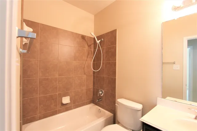 a bathroom with a toilet and shower