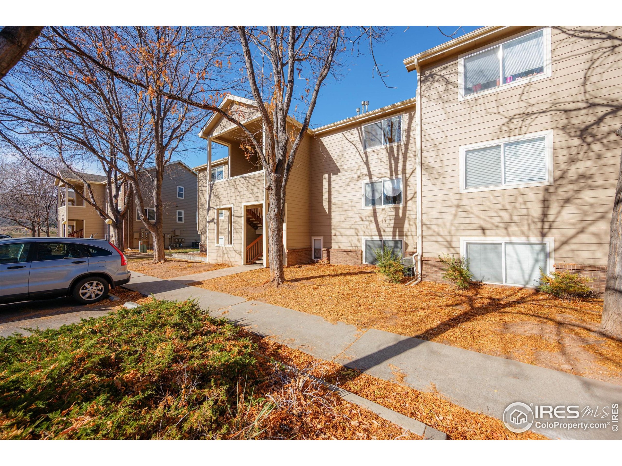 2960 West Stuart Street, Unit 304 Fort Collins, CO 80526 - Photo 1 of 28 a view of a yard with cars