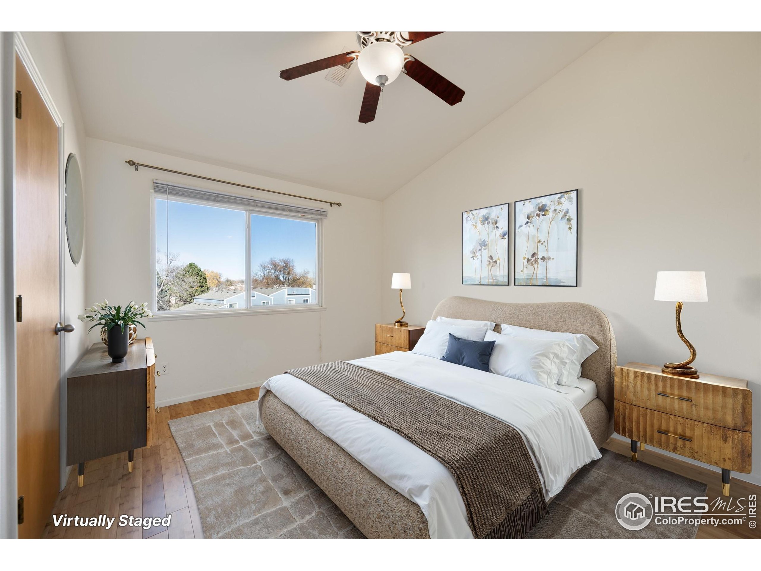2960 West Stuart Street, Unit 304 Fort Collins, CO 80526 - Photo 13 of 28 a bedroom with a large bed and a chandelier