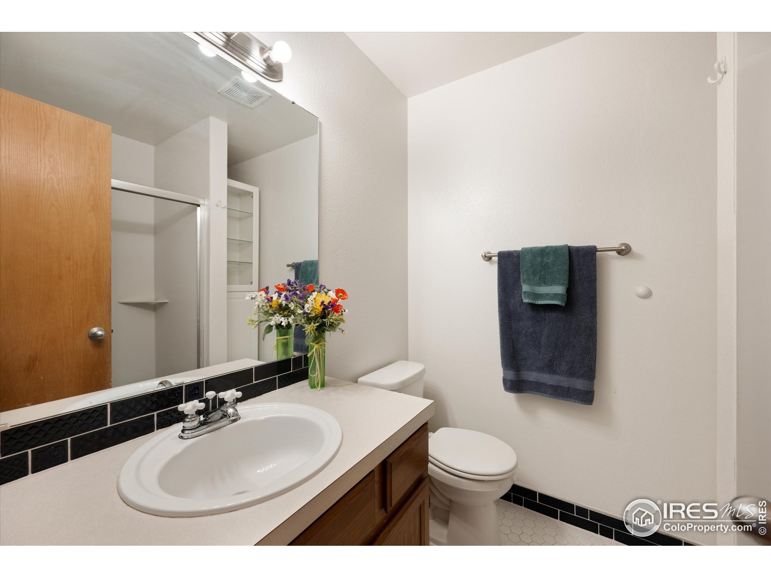 2960 West Stuart Street, Unit 304 Fort Collins, CO 80526 - Photo 16 of 28 a bathroom with a toilet sink and mirror