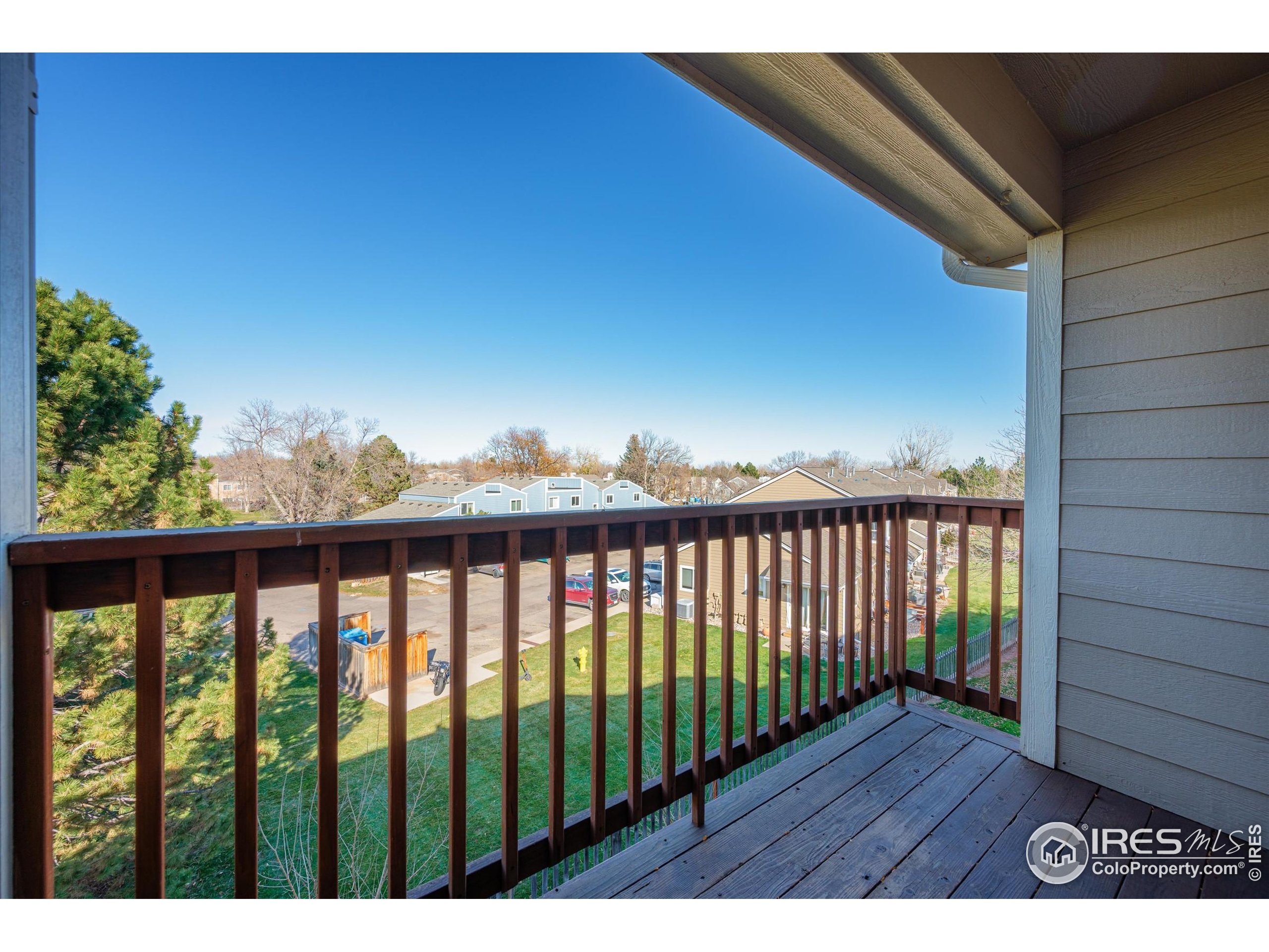 2960 West Stuart Street, Unit 304 Fort Collins, CO 80526 - Photo 21 of 28 a view of balcony with wooden fence