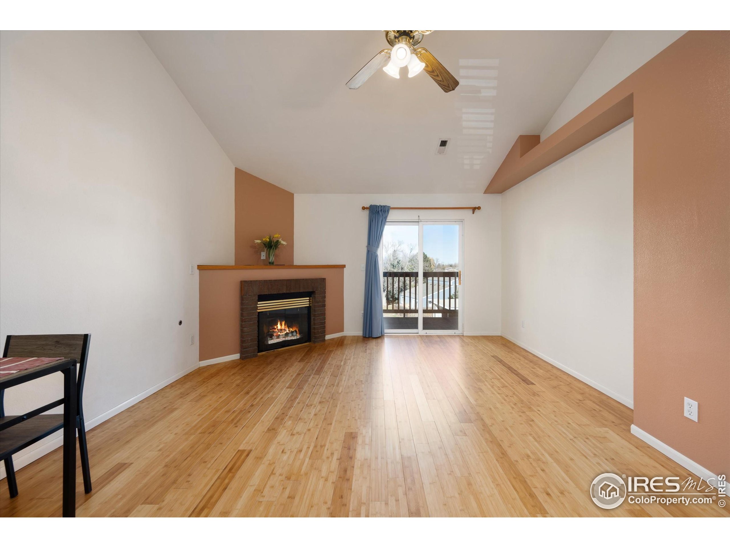 2960 West Stuart Street, Unit 304 Fort Collins, CO 80526 - Photo 4 of 28 a view of empty room with wooden floor and fireplace