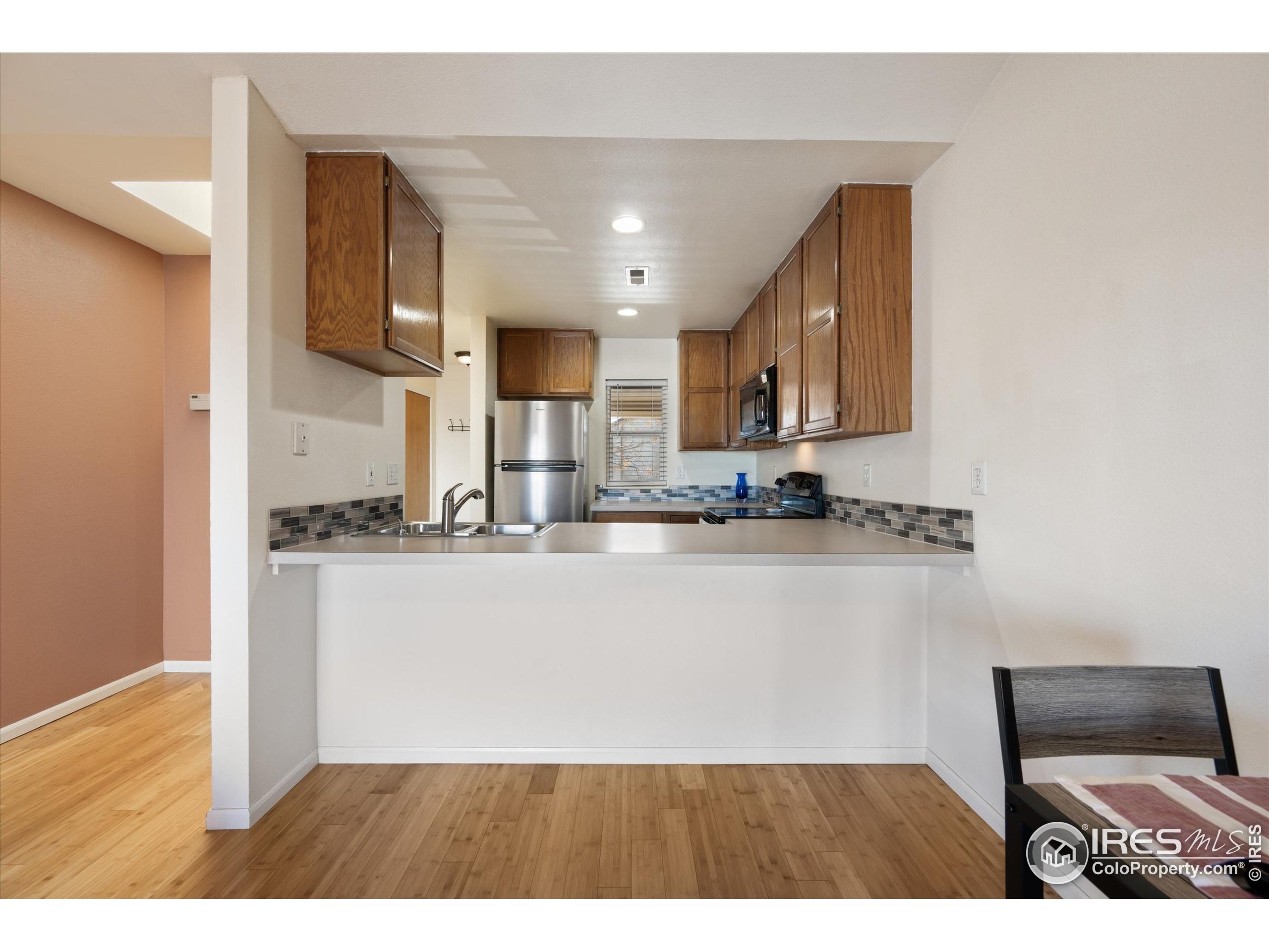 2960 West Stuart Street, Unit 304 Fort Collins, CO 80526 - Photo 8 of 28 a view of kitchen with stainless steel appliances granite countertop stove top oven and cabinets