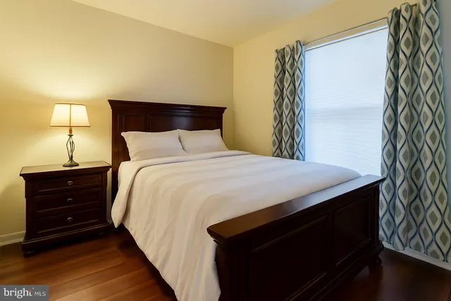 a large bed in a bedroom next to a lamp