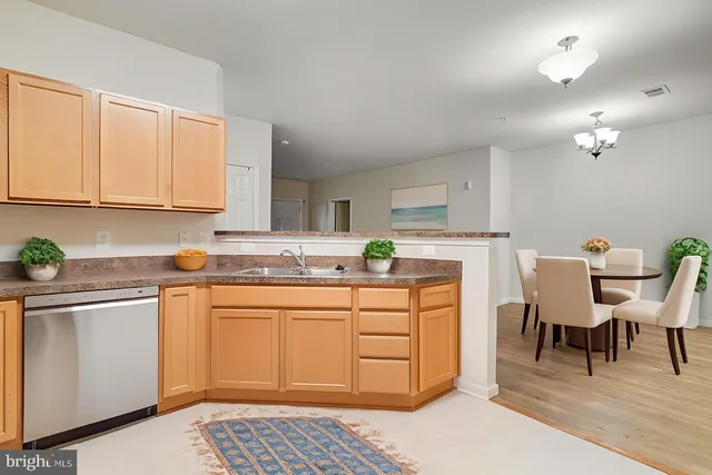 a kitchen with a white cabinets and chairs