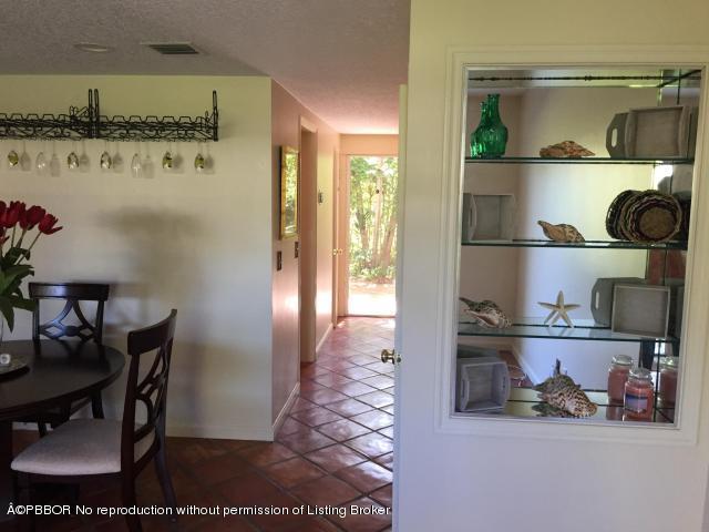 6590 North Ocean Boulevard, Unit 8 Ocean Ridge, FL 33435 - Photo 11 of 24 a kitchen with a refrigerator and wooden floor