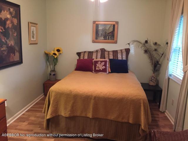 6590 North Ocean Boulevard, Unit 8 Ocean Ridge, FL 33435 - Photo 12 of 24 a bedroom with a bed and a window