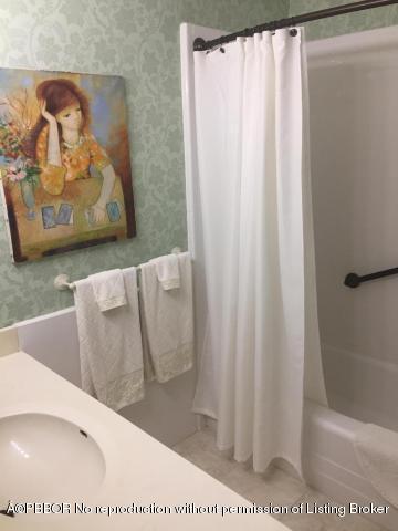 6590 North Ocean Boulevard, Unit 8 Ocean Ridge, FL 33435 - Photo 15 of 24 a picture of a bathroom with a shower curtain
