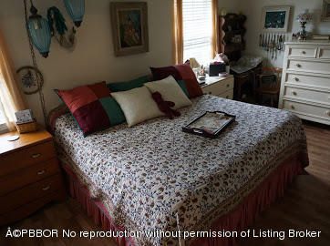 6590 North Ocean Boulevard, Unit 8 Ocean Ridge, FL 33435 - Photo 16 of 24 a bed sitting in a bedroom next to a window