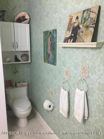 6590 North Ocean Boulevard, Unit 8 Ocean Ridge, FL 33435 - Photo 18 of 24 a bathroom with a toilet and a sink