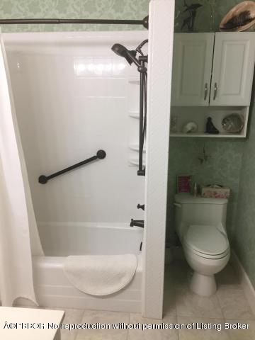 6590 North Ocean Boulevard, Unit 8 Ocean Ridge, FL 33435 - Photo 19 of 24 a bathroom with a toilet and a shower