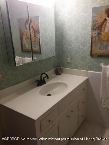 6590 North Ocean Boulevard, Unit 8 Ocean Ridge, FL 33435 - Photo 20 of 24 a bathroom with a sink and a mirror
