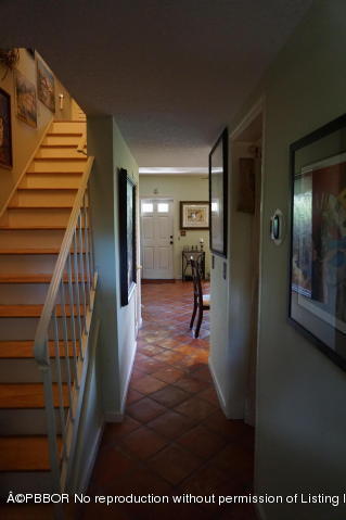 6590 North Ocean Boulevard, Unit 8 Ocean Ridge, FL 33435 - Photo 21 of 24 a view of a hallway with wooden floor and stairs