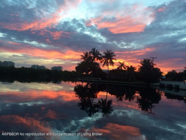 6590 North Ocean Boulevard, Unit 8 Ocean Ridge, FL 33435 - Photo 9 of 24 a view of a lake in middle of sunset