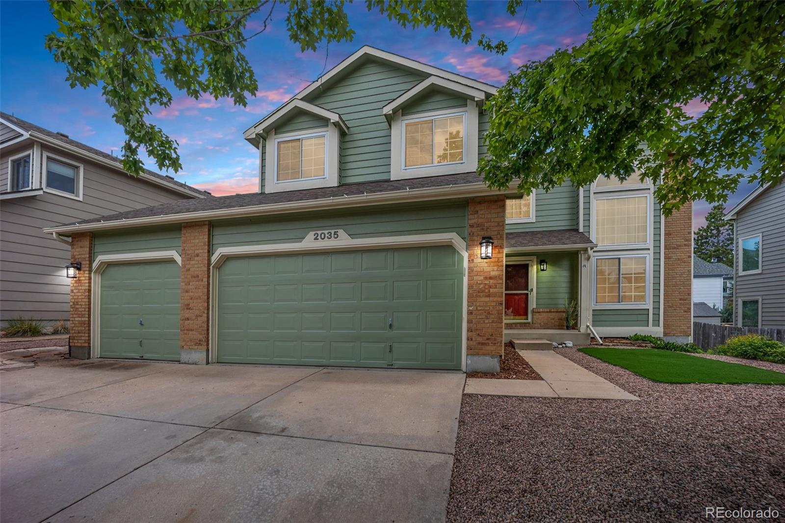 2035 Springcrest Road Colorado Springs, CO 80920 - Photo 1 of 39 a front view of a house with a yard and garage