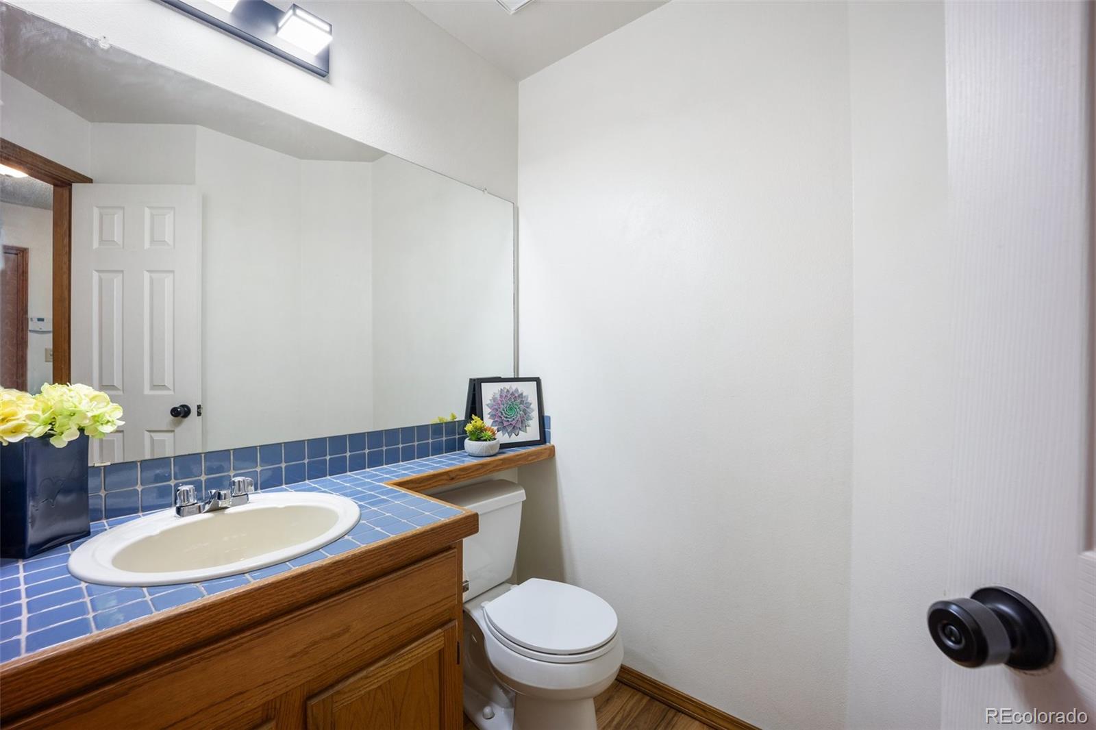 2035 Springcrest Road Colorado Springs, CO 80920 - Photo 19 of 39 a bathroom with a granite countertop sink and a mirror
