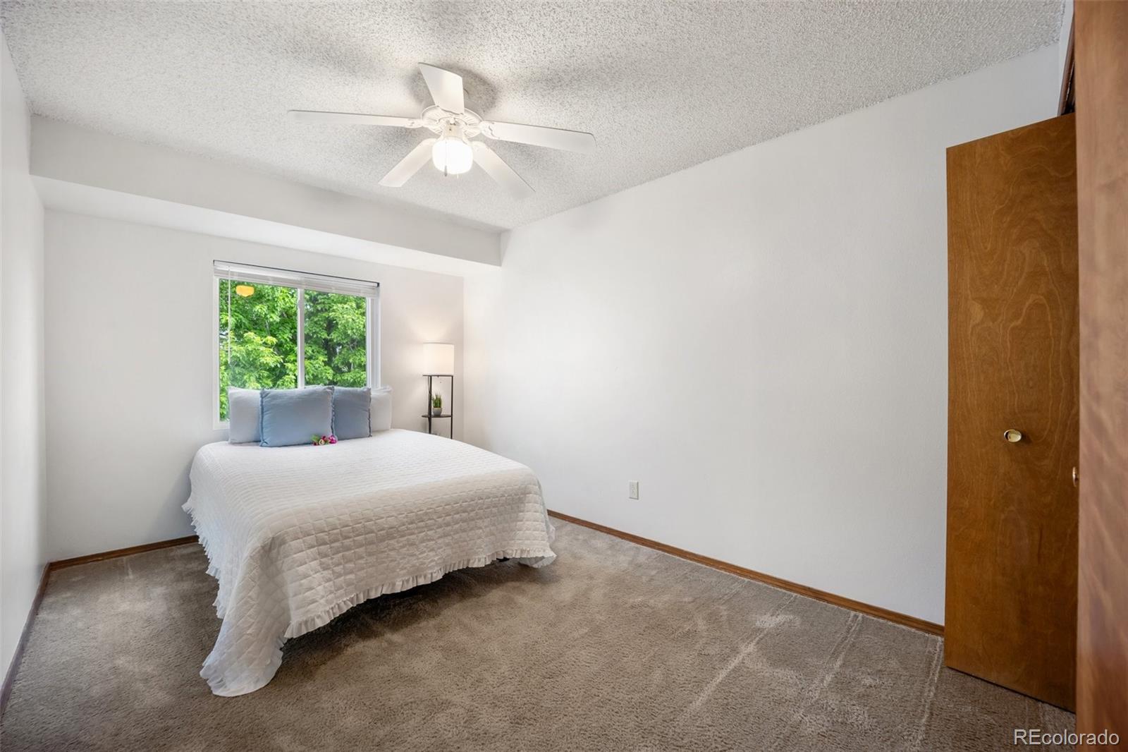2035 Springcrest Road Colorado Springs, CO 80920 - Photo 21 of 39 a bedroom with a bed and a window