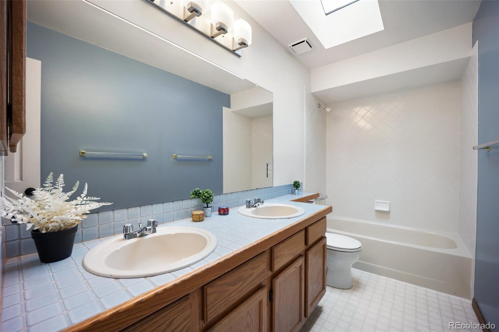 2035 Springcrest Road Colorado Springs, CO 80920 - Photo 23 of 39 a bathroom with a double vanity sink bathtub and a toilet