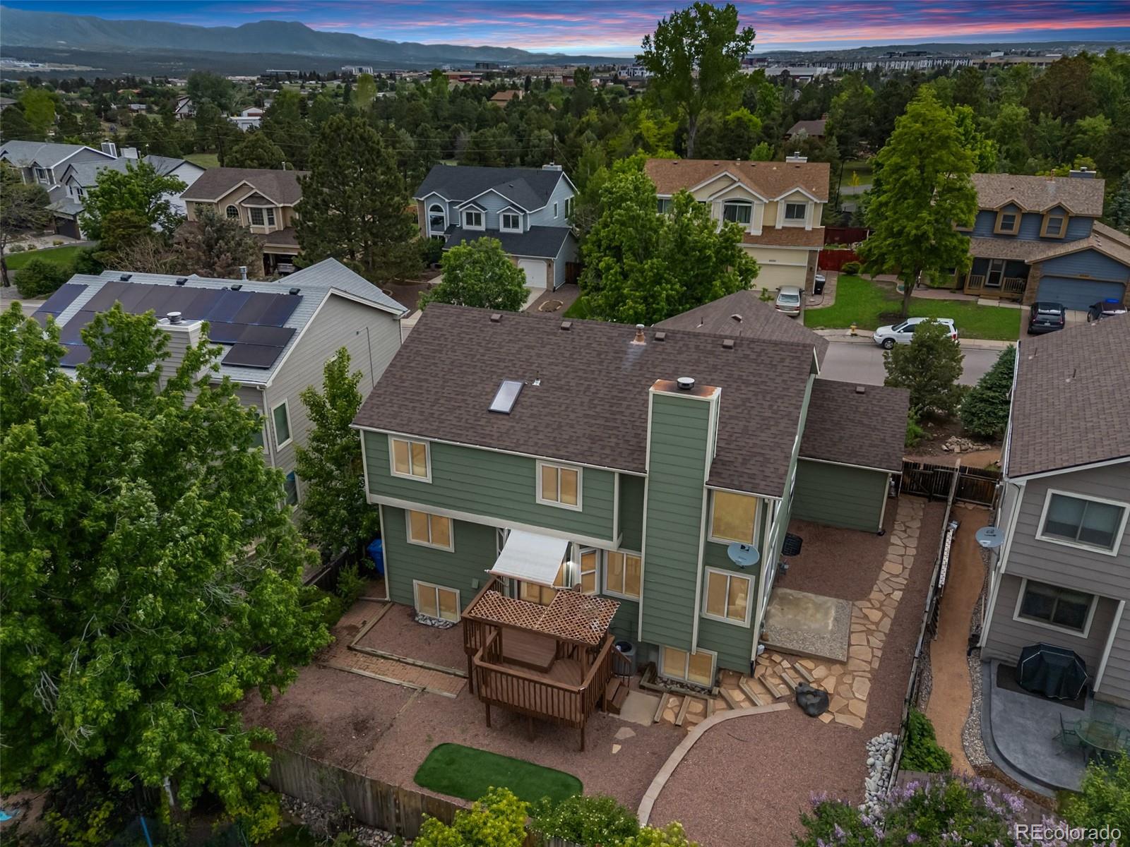 2035 Springcrest Road Colorado Springs, CO 80920 - Photo 3 of 39 an aerial view of a house with garden space and street view