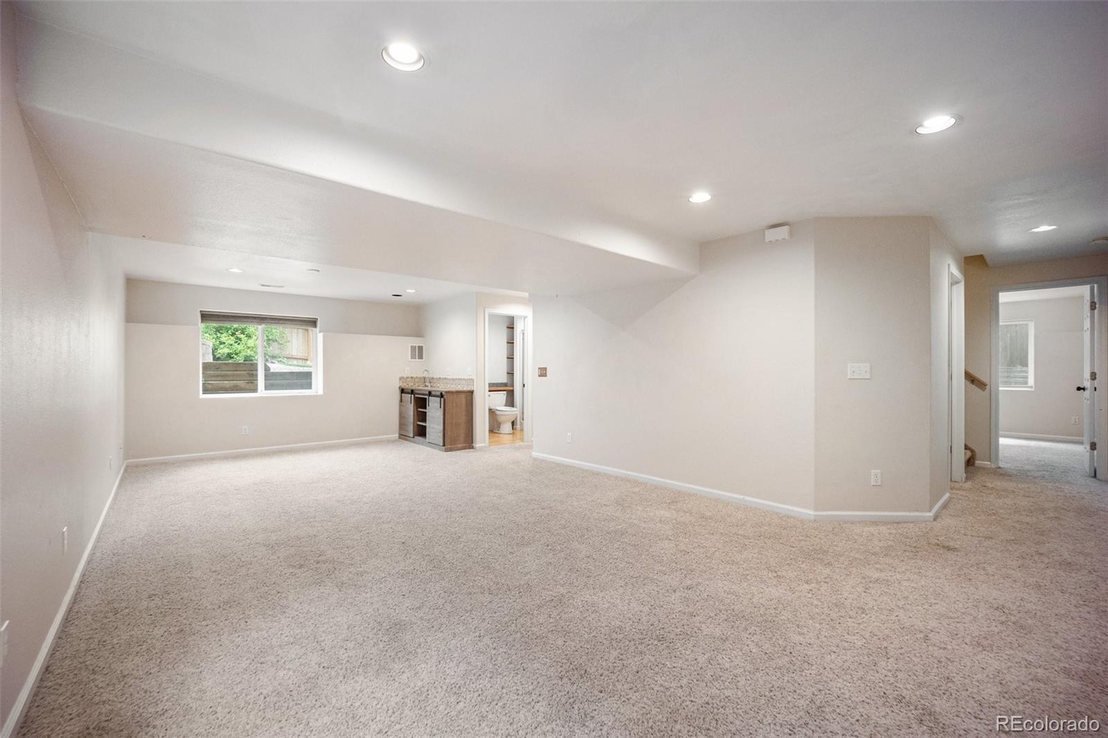 2035 Springcrest Road Colorado Springs, CO 80920 - Photo 32 of 39 an empty room with windows and pillars in it