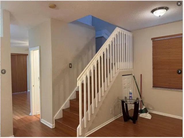a view of staircase with lots of frames and a rug