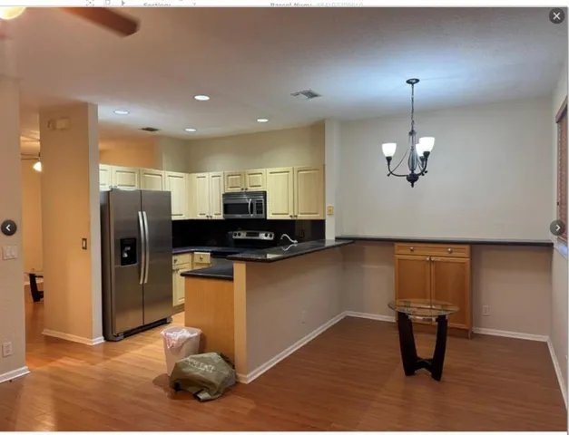 a kitchen with stainless steel appliances kitchen island a refrigerator sink and stove