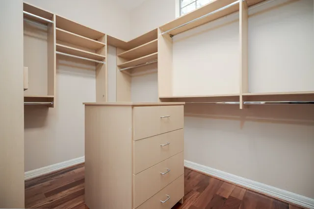 a view of walk in closet with empty racks