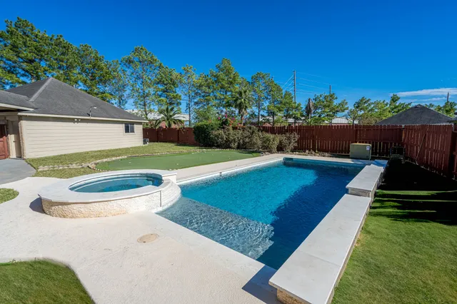 a view of a backyard with sitting area