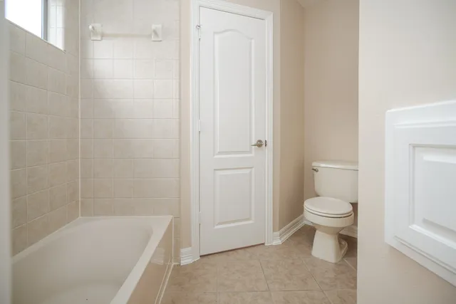 a bathroom with a toilet and a bathtub