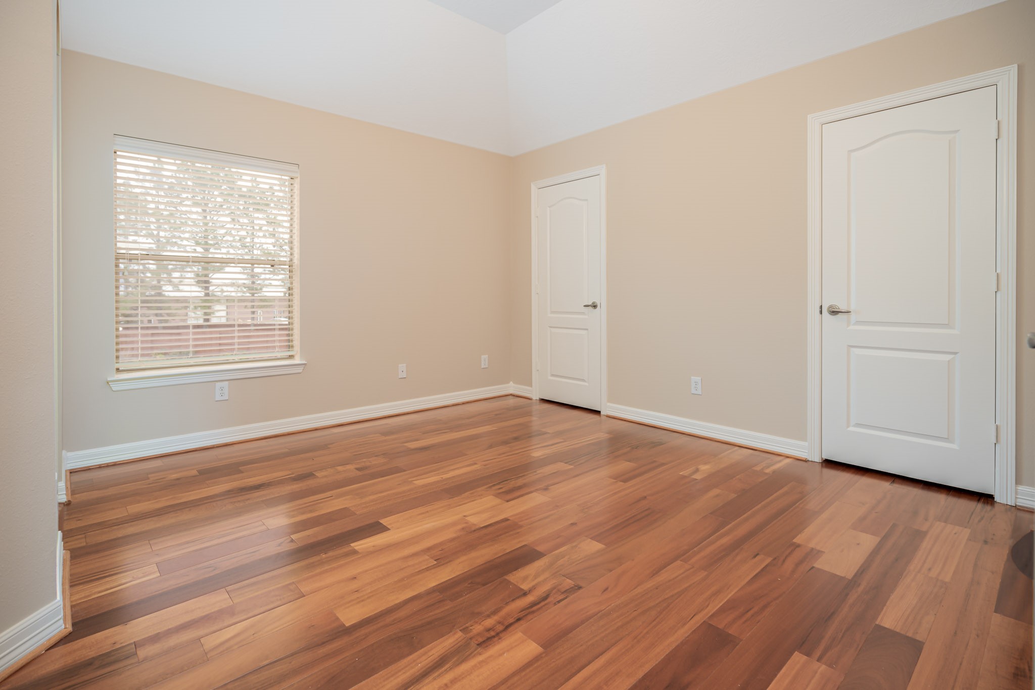 6506 Monte Bello Ridge Lane Houston, TX 77041 - Photo 20 of 35 an empty room with wooden floor and windows