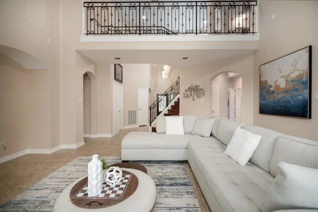 a living room with furniture and a wooden floor