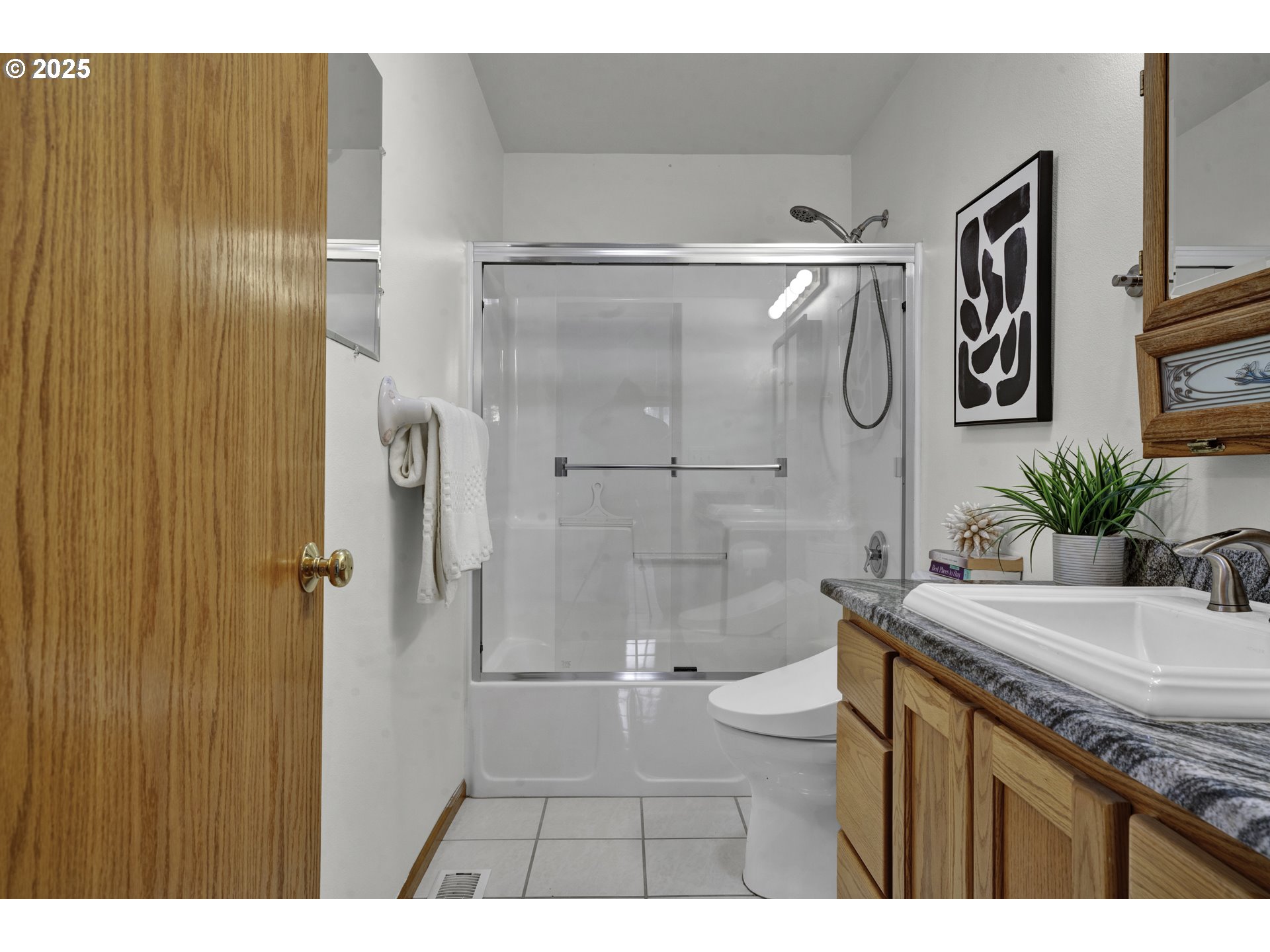 1002 South 69th Street Springfield, OR 97478 - Photo 17 of 44 a bathroom with a granite countertop sink a toilet and shower