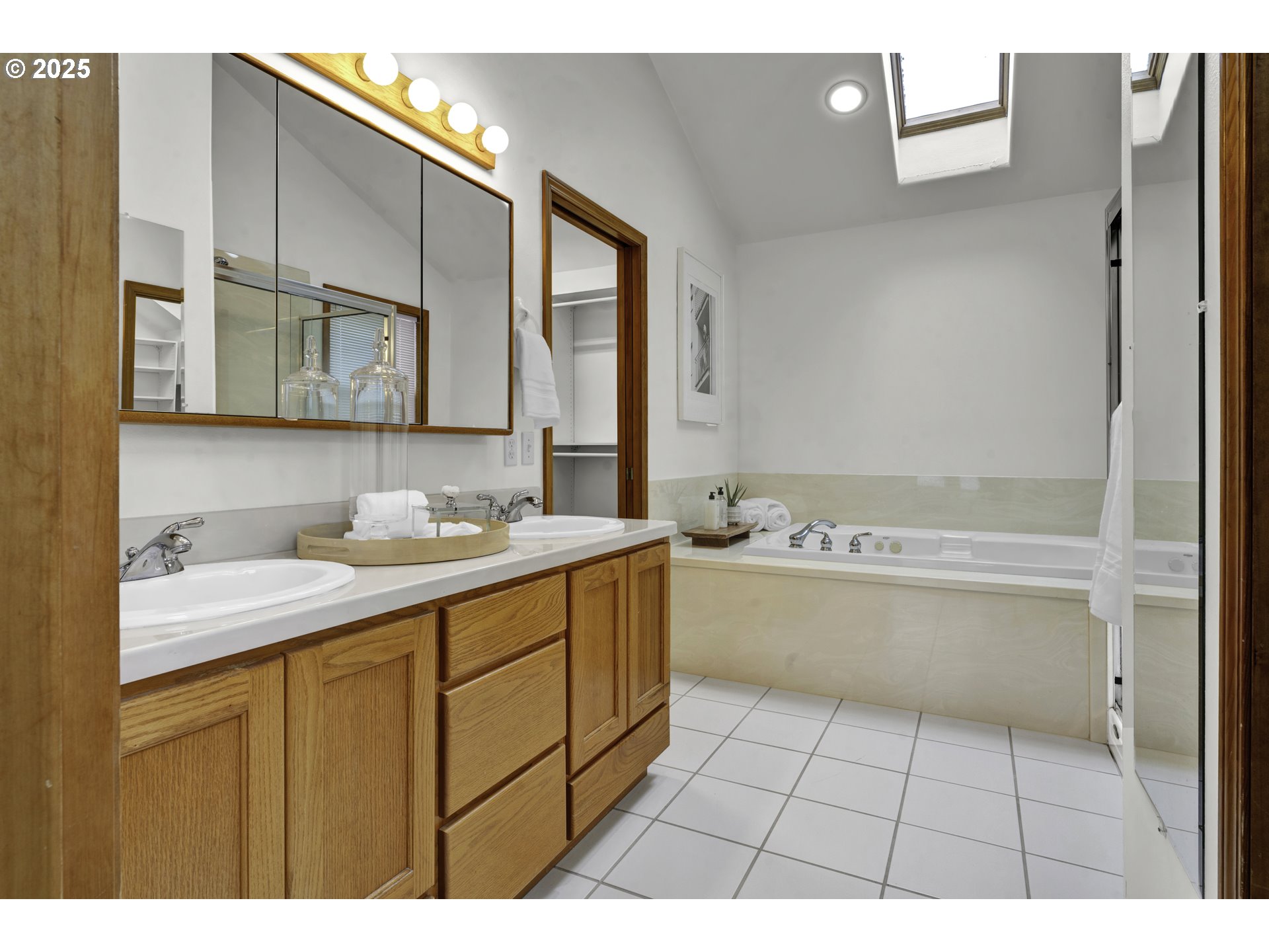 1002 South 69th Street Springfield, OR 97478 - Photo 23 of 44 a bathroom with a sink a mirror and a bathtub