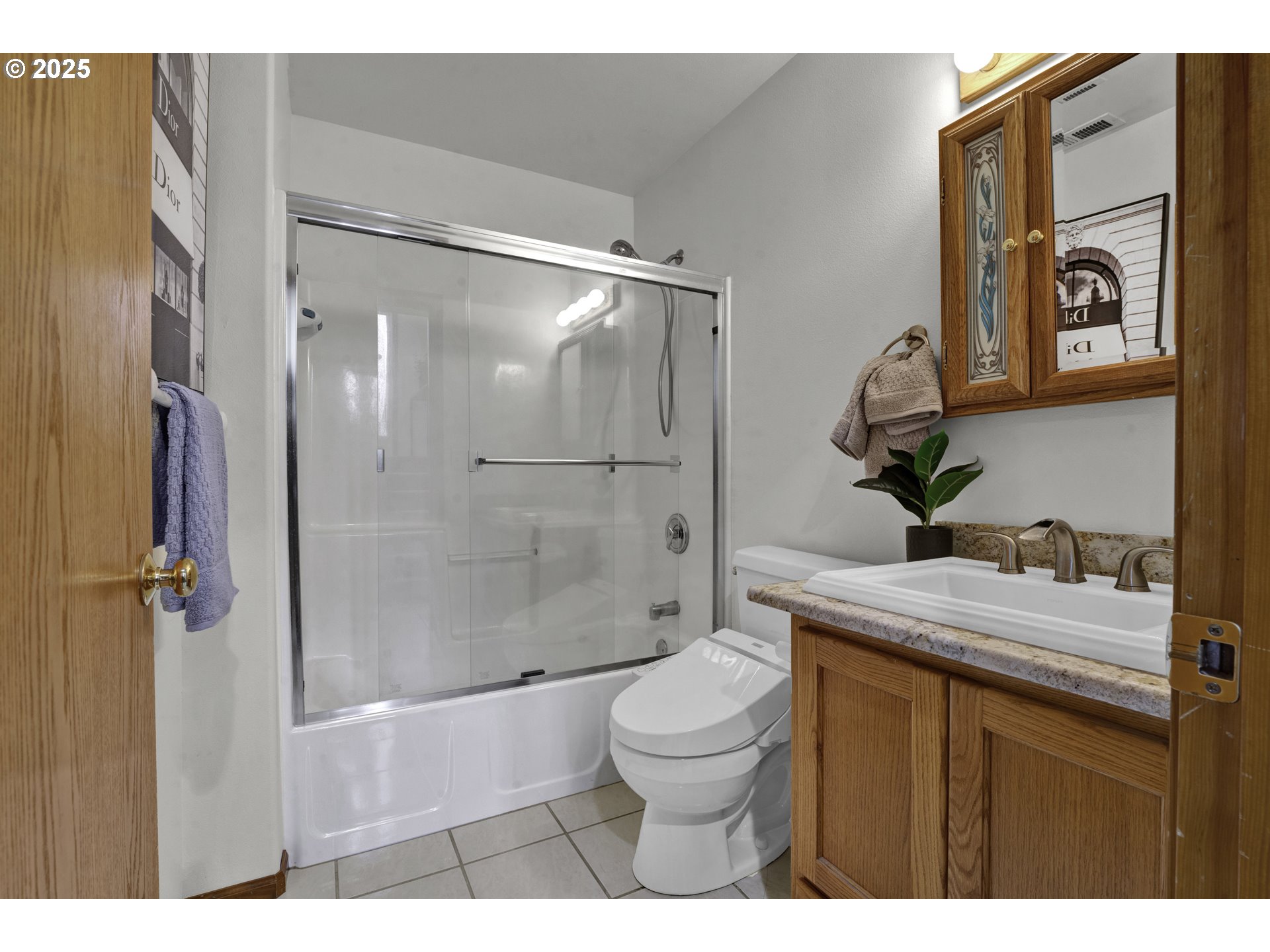 1002 South 69th Street Springfield, OR 97478 - Photo 31 of 44 a bathroom with a granite countertop sink toilet a mirror and shower