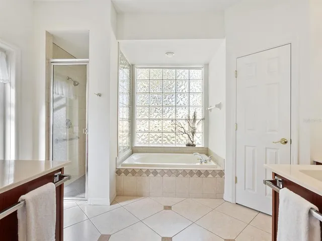 a spacious bathroom with a bathtub and shower