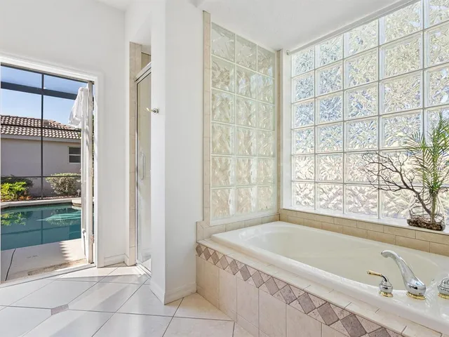 a bathroom with a tub a sink and a shower
