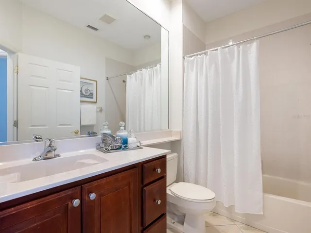 a bathroom with a double vanity sink toilet and a mirror