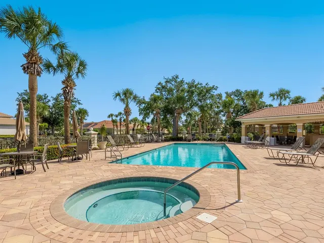 a view of swimming pool with outdoor seating and plants