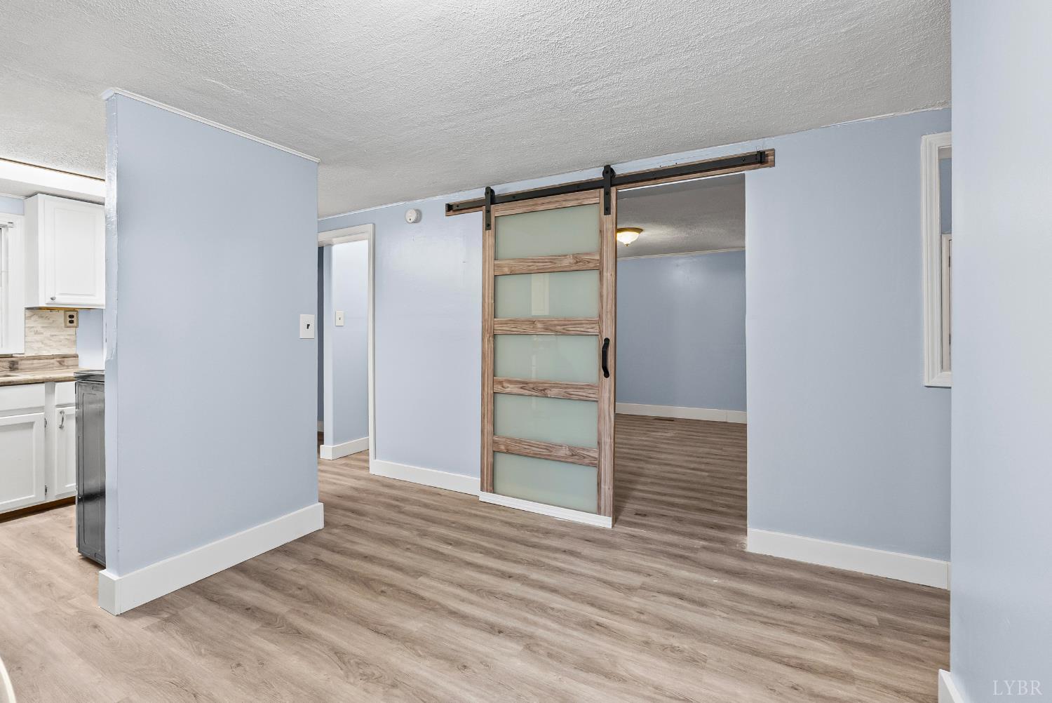 2443 Sunnymeade Road Rustburg, VA 24588 - Photo 13 of 36 a view of an empty room with wooden floor and closet