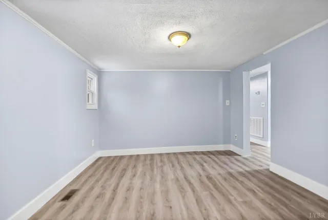 a view of room with wooden floor