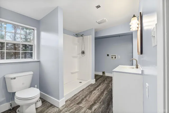a bathroom with a sink toilet and shower