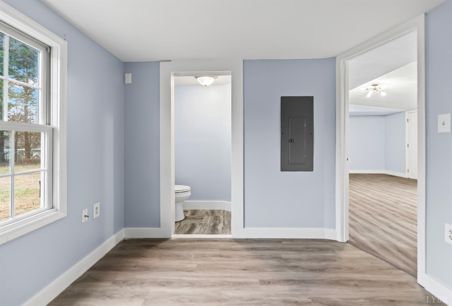 2443 Sunnymeade Road Rustburg, VA 24588 - Photo 23 of 36 a view of an empty room with wooden floor and a window